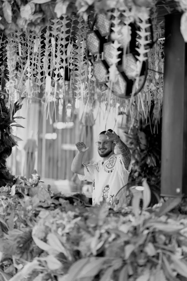 OPPAACHA playing a daytime set framed by tropical plants and woven decor